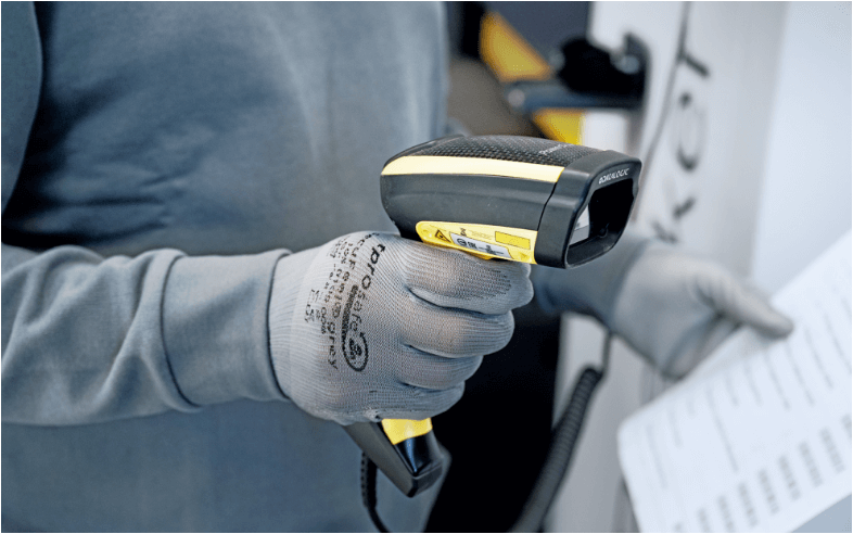 Employee using barcode scanner for part data entry